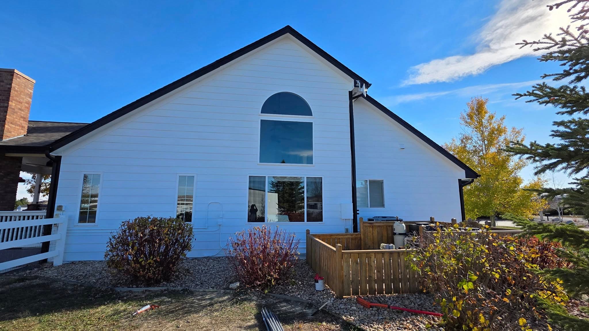 Finished home with arched window and metal roofing