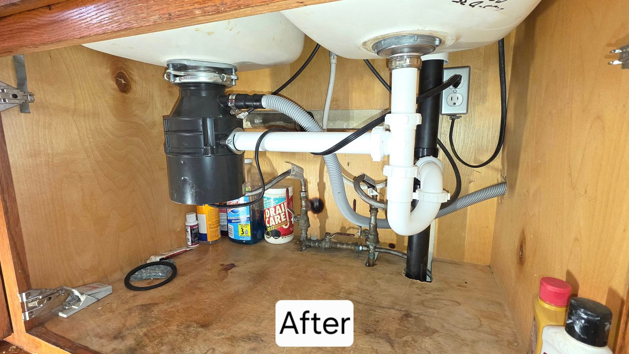New under-sink plumbing installation with clean fixtures and pipes