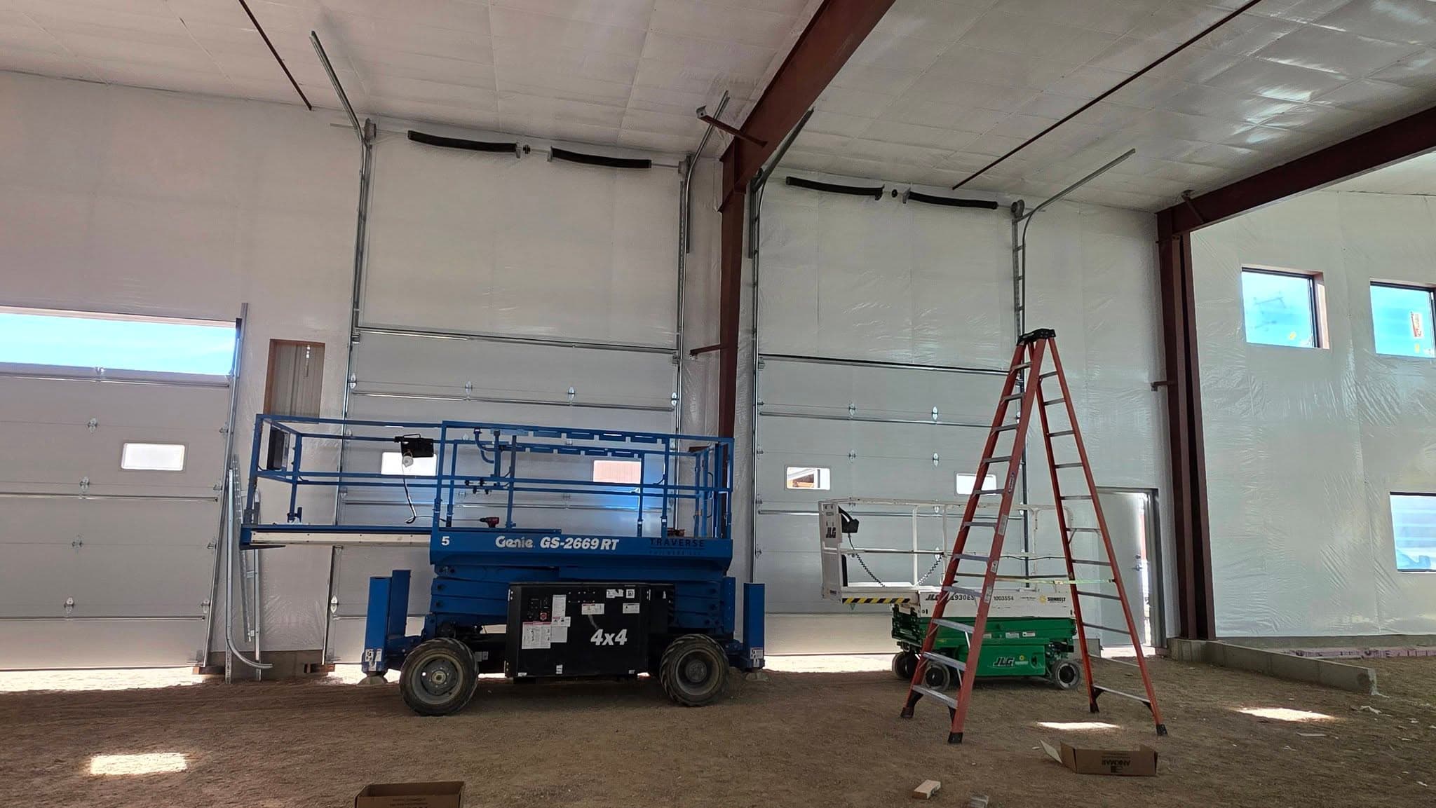Lift equipment inside a large industrial garage space